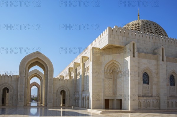 Arched gates and large hall with dome of the Sultan Qaboos Mosque, Muscat, Arabian Peninsula, Sultanate of Oman