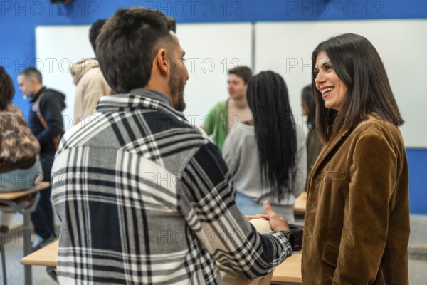 Multi ethnic university students chatting with their teacher after class, discussing lesson topics and asking questions