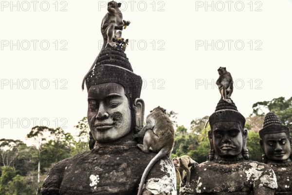 Figures and monkeys on the bridge to Angkor Thom, macaques, sunset, Angkor Wat, Angkor, UNESCO World Heritage Site, Siem Reap, Cambodia, Indochina, Southeast Asia