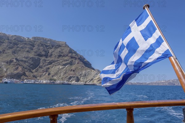 Greek flag waving in the wind on a boat, Greece