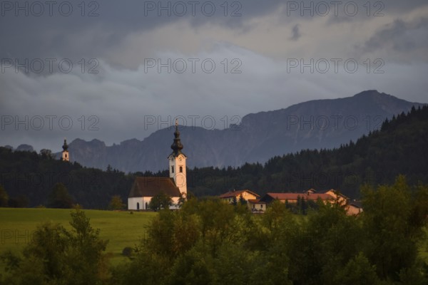 View from the Ainringer moss nature reserve to Ulrichshögl with the Lattengebirge in the background at sunset, Bavaria, Germany