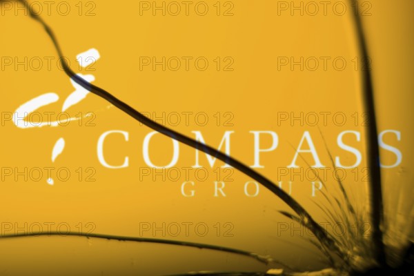 Compass Group logo is visible on the broken glass