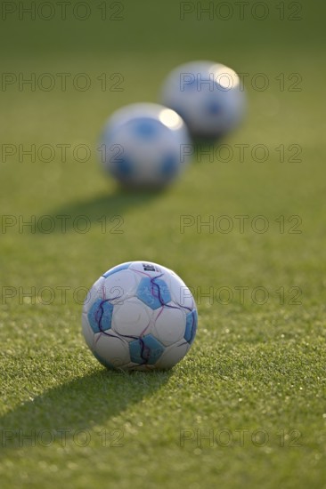 Adidas Derbystar match balls lying on grass, backlight, Voith-Arena, Heidenheim, Baden-Württemberg, Germany