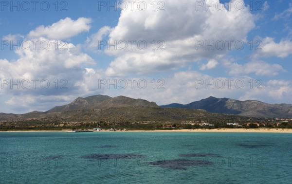 A wide view over the sea with mountains and clouds in the background, view to Pounta beach near Viglafia, Vigklafia, Laconia, Peloponnese, Greece