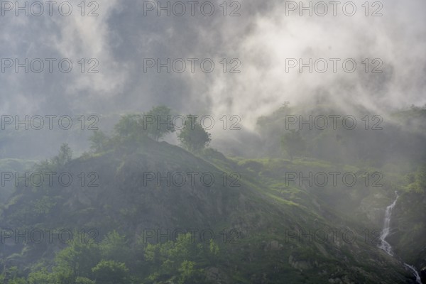 Clouds move over the mountains after a rain shower at Lago della Rovina, Entracque, province of Cuneo, Italy
