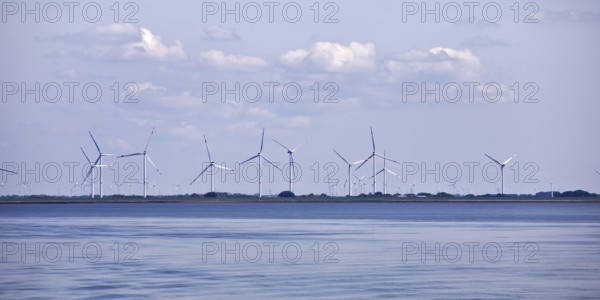 Schleswig-Holstein Wadden Sea National Park with a view of wind turbines on the mainland, North Frisia, Germany