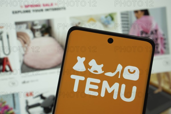 Dhaka, Bangladesh - 18 March 2025: The logo of the Temu is displayed on a smartphone screen, and the website temu is visible on a computer screen in the background