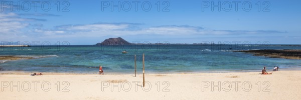 Panoramic photo of Corralejo beach in the background uninhabited island Islote de Lobos in the East Atlantic with cone of former volcano Montaña La Caldera, Corralejo, Fuerteventura, Canary Islands, Canary Islands