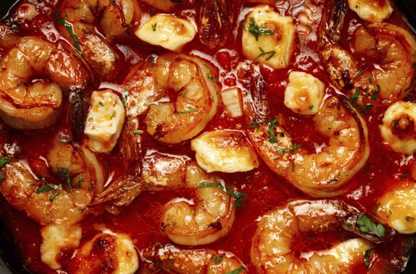 Greek saganaki, in an iron pan, saganaki with shrimp, shrimp in tomato sauce, with pepper and feta cheese, homemade, no people