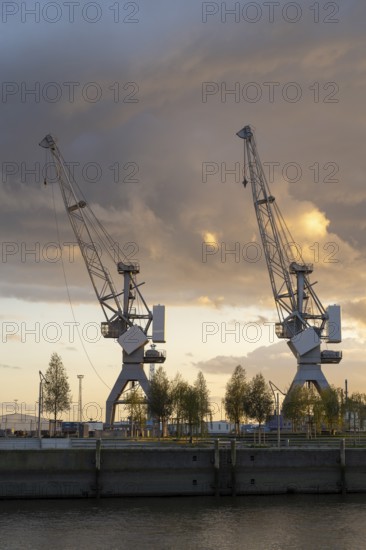 Dramatic clouds over the Strandkai, historic crane, sunset, Überseequartier, Hafencity, Hamburg, Germany