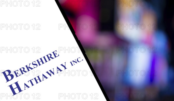 Berkshire Hathaway inc logo is displayed on smartphone. Berkshire Hathaway Inc is an American multinational conglomerate holding company.