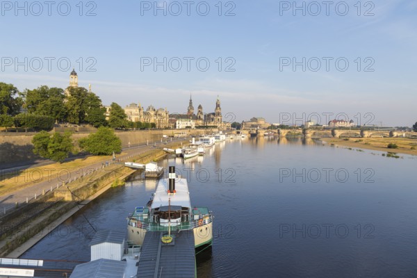 Silhouette of the Old Town with reflection in the Elbe in the morning, steamboats on the Terrassenufer, Brühl's Terrace, Church of Our Lady, Academy of Fine Arts, Secondary School, Hausmannsturm, Ständehaus, Court Church, Semper Opera House and Augustus Bridge, Dresden, Saxony, Germany