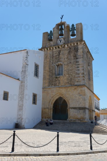 Historic church with bell tower, surrounded by white buildings, under a bright blue sky, Sé Catedral de Faro, Cathedral of Faro, Largo da Sé, Faro, Algarve, Portugal