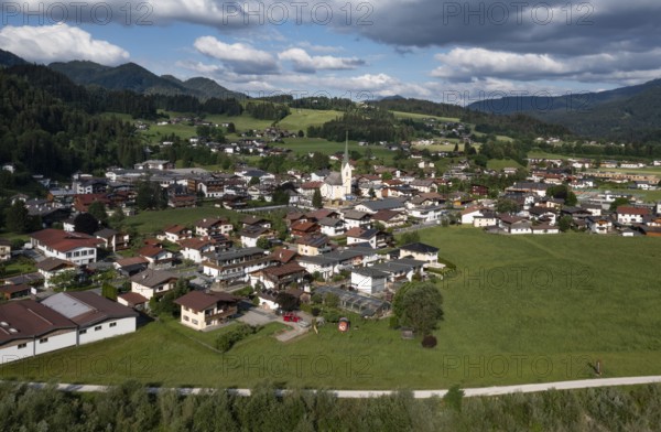 Drone shot, view of the village with parish church, Kössen, Leukental, Tyrol, Austria