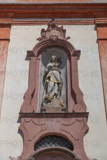 Sculpture of the Virgin Mary above the entrance portal of the baroque St Martin's Church, Riegel am Kaiserstuhl, Baden-Württemberg, Germany