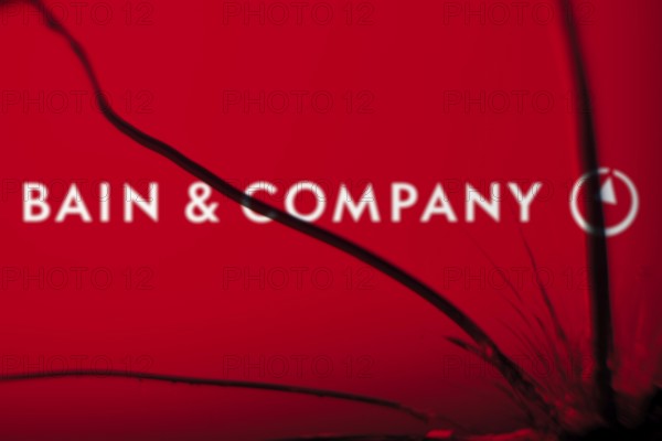 Bain & Company logo is visible on the broken glass. Bain & Company is an American management consulting company