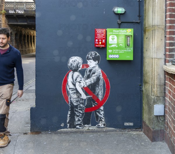 Mural street art two young boys one with knife Anti knife piece 2020 by JPS artist Jamie Scanlon, Frogmore Street, Bristol, England, UK
