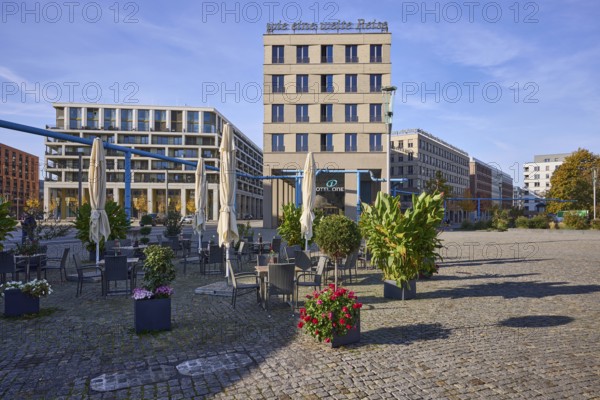 Hotel of the Motel One hotel chain, outdoor area of a restaurant, planters, above-ground district heating pipe, blue sky with veil clouds, Postplatz, Dresden, state capital, independent city, Saxony, Germany