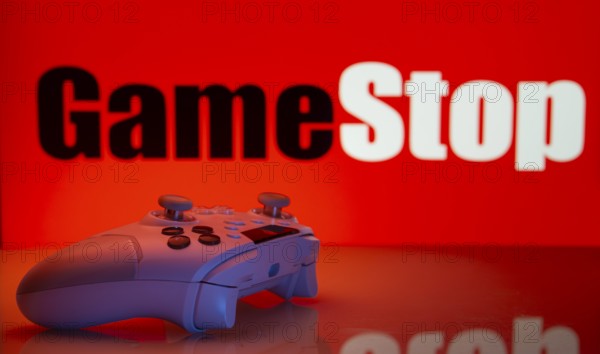 Dhaka, Bangladesh- 15 July 2025: Game controller in front of GameStop logo on a background