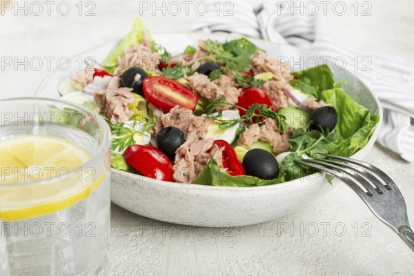 Salad with canned tuna, vegetable salad with quail eggs, lettuce and romaine leaves, red onion, cherry tomatoes, olives, keto food, healthy eating
