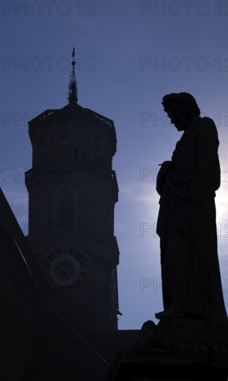 Silhouette, Schiller monument to Friedrich Schiller, octagonal church tower of the collegiate church, Schillerplatz, Old Town, Stuttgart, Baden-Württemberg, Germany
