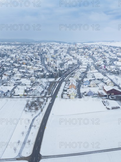 Aerial view of a small snow-covered village surrounded by fields, Deckenpfronn, Böblingen district, Germany