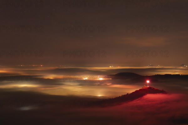 New Year's Eve fireworks 2024 on the Breitenstein, Swabian Alb near Ochsenwang. Sea of fog in the foothills of the Alb. View of the Drei Kaiserberge near Göppingen. In the foreground the Limburg and the Aichelberg