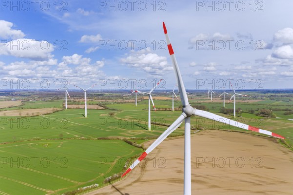 Aerial view over wind turbines at wind park, windfarm in Schleswig-Holstein, Germany