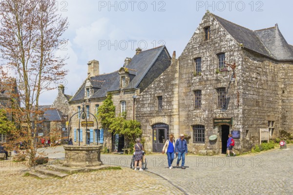 City square with tourist and stone houses in the old town Locronan, Locronan, Bretagne, France