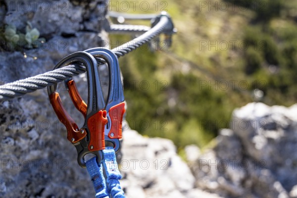 Two via ferrata carabiners hanging in the steel cable of a via ferrata, Jenner, Berchtesgaden National Park, Schönau am Königssee, Upper Bavaria, Bavaria, Germany