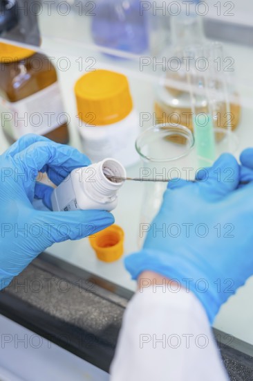 A spoon is inserted into a small bottle of chemicals, Nagold Youth Research Centre, Black Forest North, Calw district, Germany