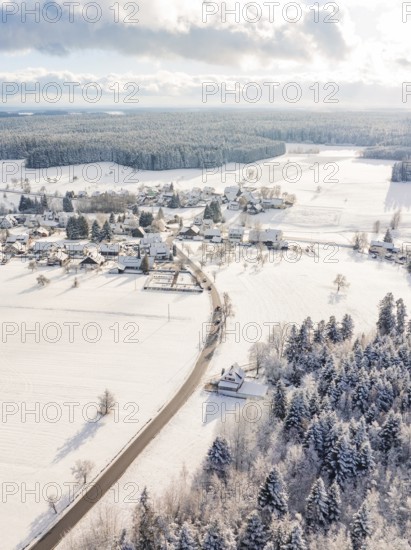 Snowy village with fields and trees, quiet winter atmosphere with sunny sky, Oberreichenbach, Black Forest, Calw district, Germany