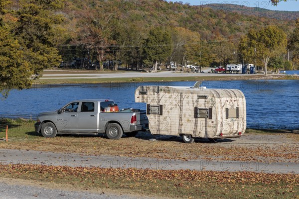 Travel trailer camper at a camp site at Marion County Park on the shore of the Nickajack Lake in Jasper, Tennessee, USA
