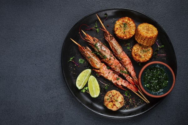 Langoustines on skewers, shrimp kebab, with fried corn, spices and herbs, homemade, no people