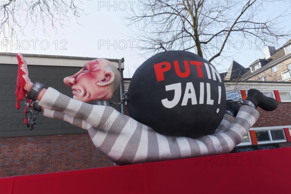 Russian President Vladimir Putin as a convict with blood on his hands, Put In Jail, papier-mâché figure, theme float by Jacques Tilly, Rosenmontagszug 2025, Düsseldorf, Rhineland, North Rhine-Westphalia, Germany