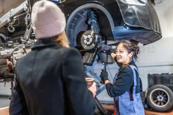 Skilled mechanic discussing vehicle maintenance with a customer, highlighting professionalism and expertise in automotive repair
