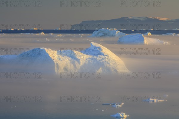 Icebergs in the fog, midnight sun, summer, Ilulissat, Ilulissat Icefjord, Disko Bay, West Greenland, Greenland