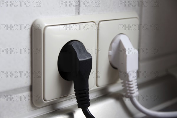 Double socket outlet, mains plug, black, white, electricity, household, Two different coloured mains plugs are plugged into the socket outlet