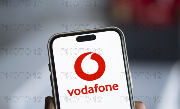 Vodafone logo is displayed on smartphone.
