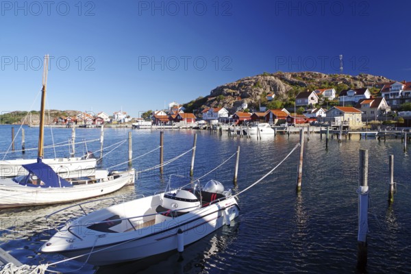 Small harbour with white boats and colourful houses on a sunny day, archipelago coast, Hamburgsund, Bohuslän, Sweden
