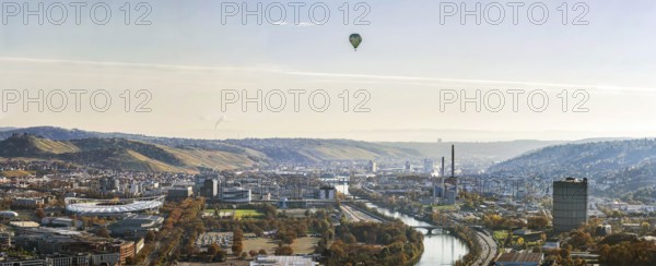 Stuttgart and the Neckar valley with vineyards. In the centre of the picture are the headquarters of Mercedes-Benz Group AG, the Mercedes Museum and the MHP Arena. Aerial view, panoramic photo. Stuttgart, Baden-Württemberg, Germany