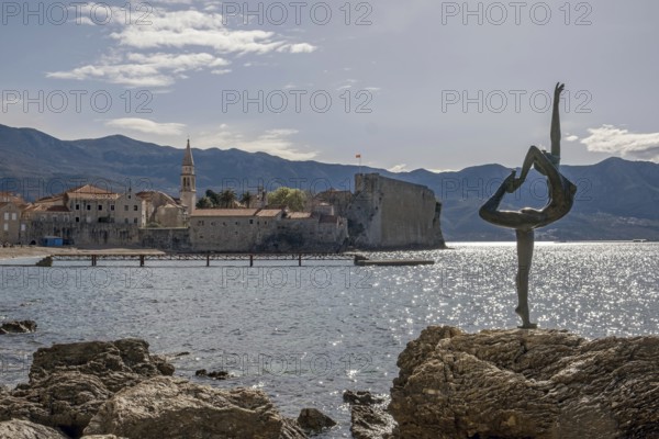 Statue of a ballerina against the background of the old town centre of Budva, Montenegro, Balkans