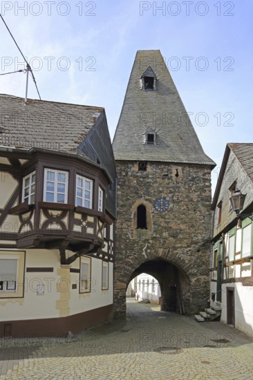 Historic clock tower and half-timbered house with oriel, landmark, town gate, town tower, Herrstein, Hunsrück, Rhineland-Palatinate, Germany