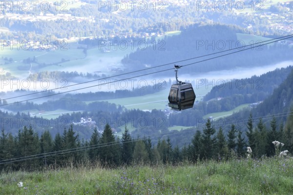 Gondola of the Jennerbahn in front of the valley basin of Berchtesgaden with fog in the early morning, Bavaria, Germany
