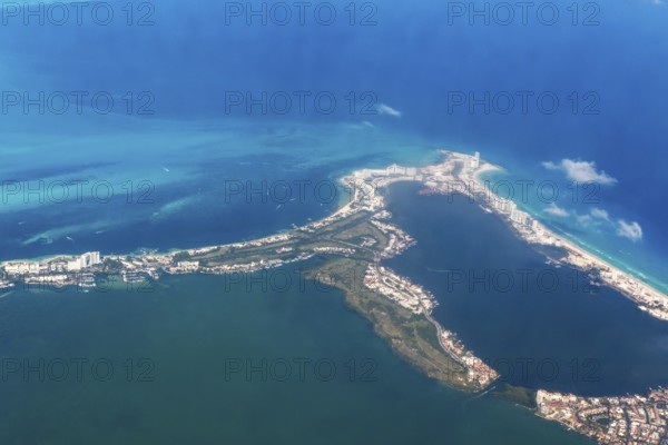 Aerial view through plane window of Caribbean coastline buildings in the hotel zone, Cancun, Quintana Roo, Yucatán Peninsula, Mexico