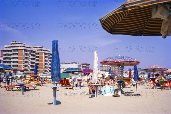 People sunbathing on the sandy beach of Rimini, Emilia Romagna region, Italy 1969