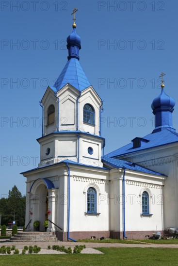 White orthodox church with a striking blue roof, surrounded by nature under a bright sky, Orthodox Church of the Assumption of the Virgin Mary, Dubiny, Podlaskie Voivodeship, Podlaskie, Poland
