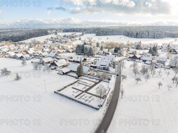 Snow-covered village with church and surrounding fields and forests, Oberreichenbach, Black Forest, Calw district, Germany