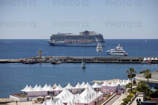 Cannes, France - 23 May 2024: A cruise ship anchors in front of the beach on the Promenade de la Croisette during the 78th Cannes International Film Festival. The film festival will take place from 13 to 24 May 2025