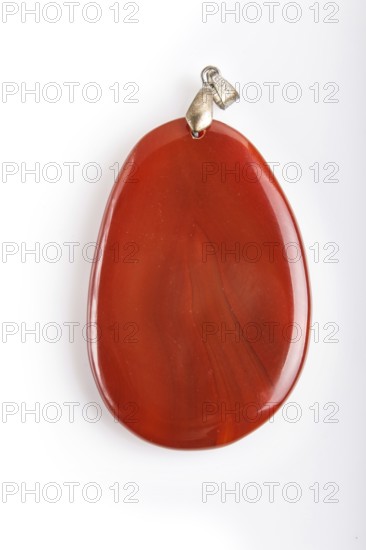 Red onyx pendant isolated on white background, close up
